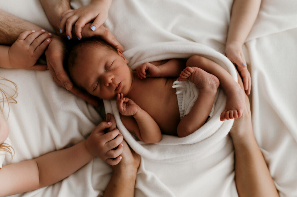 Cozy studio newborn session with natural light and neutral wardrobe