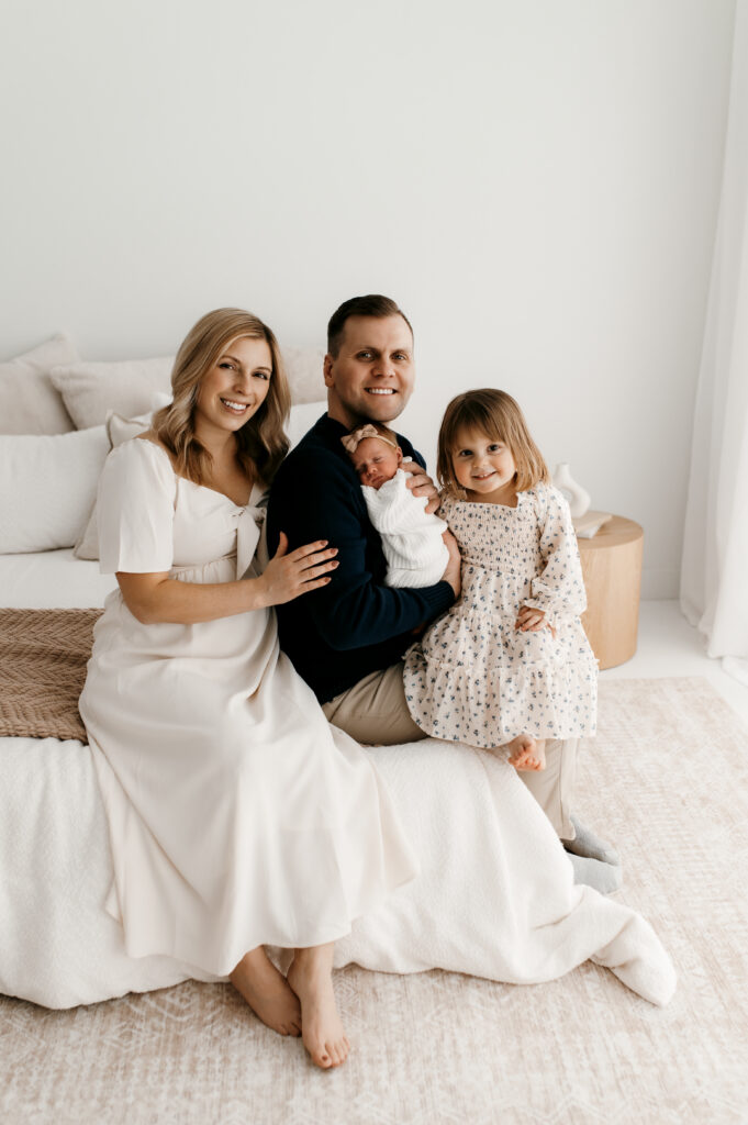 Neutral family outfits coodinated for natural light studio photo shoot. 