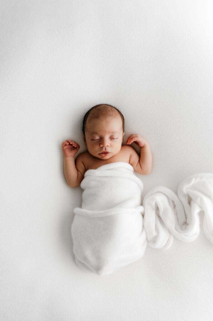 Sleepy newborn baby photographed in a neutral Somerset WI photography studio
