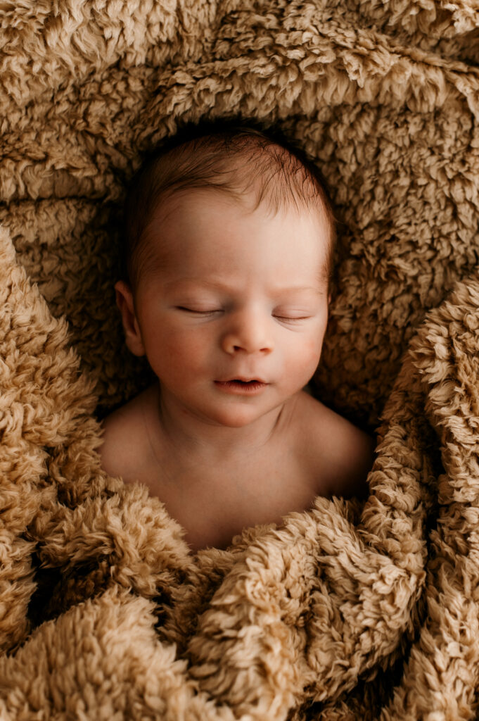 Sleepy newborn baby photographed in a neutral Somerset WI photography studio