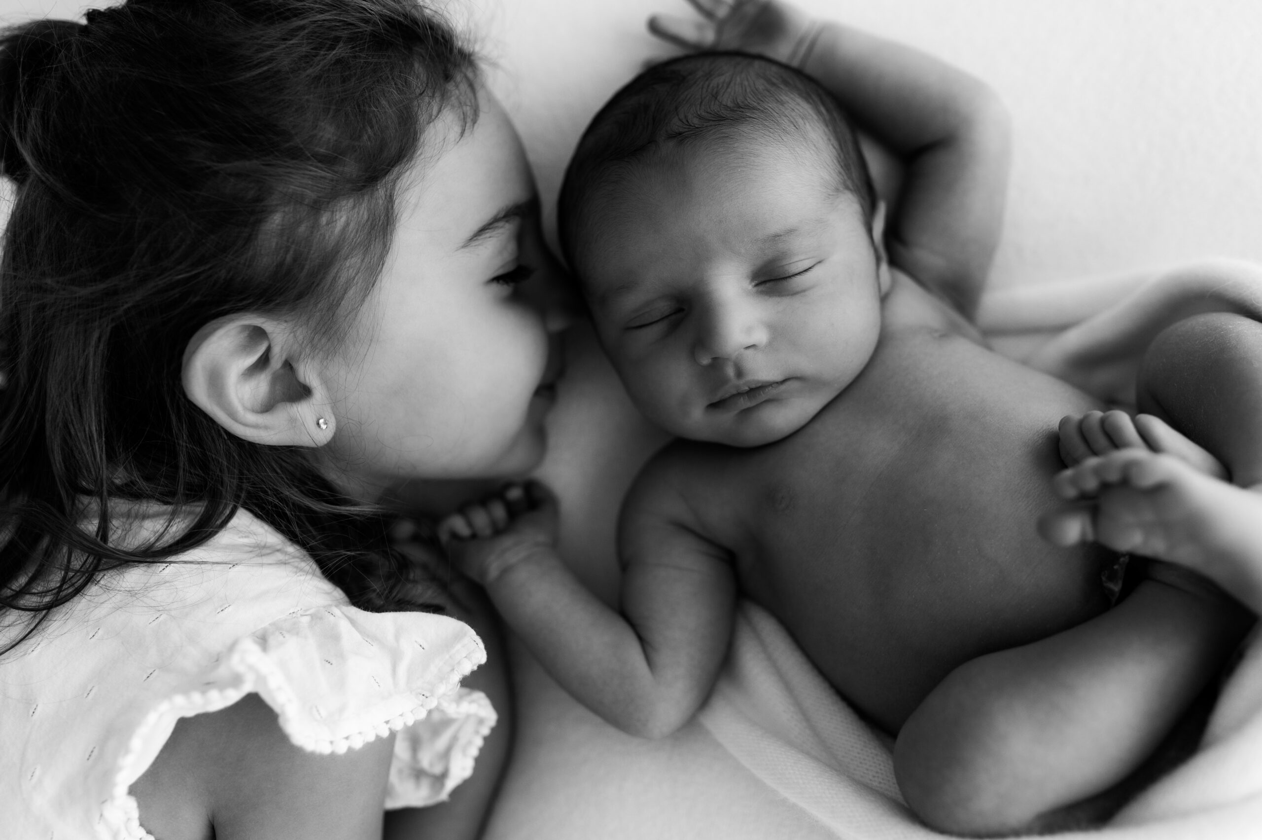 Peaceful newborn laying on back in minimal setup