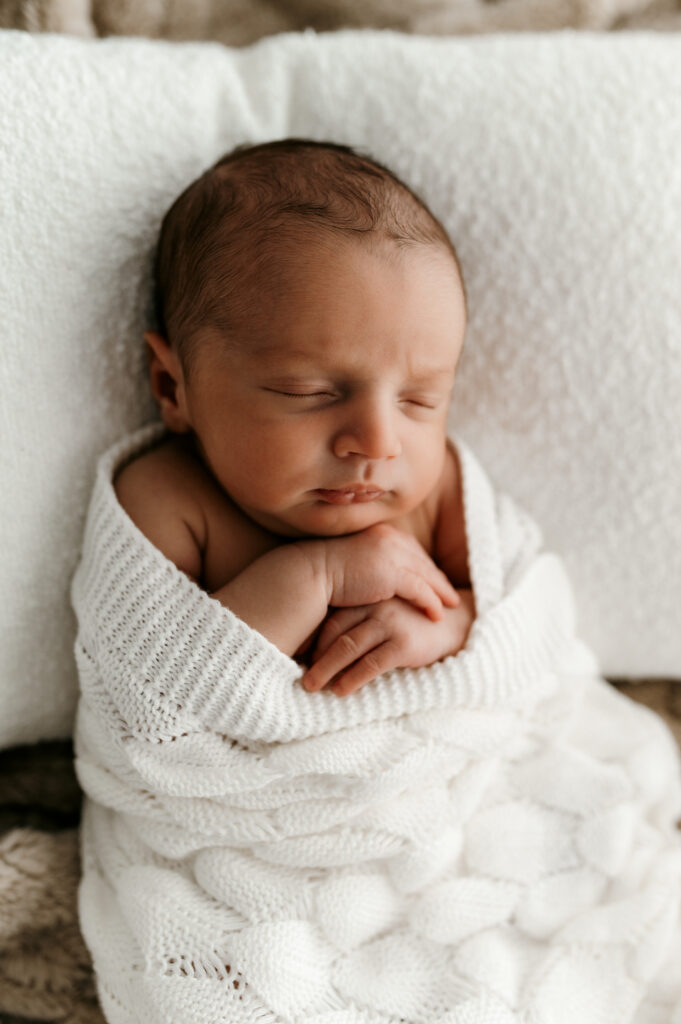 Sleepy newborn baby photographed in a neutral Somerset WI photography studio
