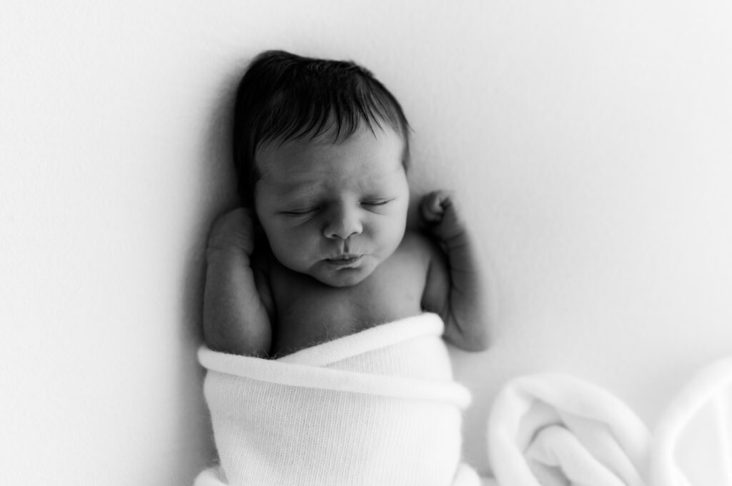 Sleepy newborn baby photographed in a neutral Somerset WI photography studio