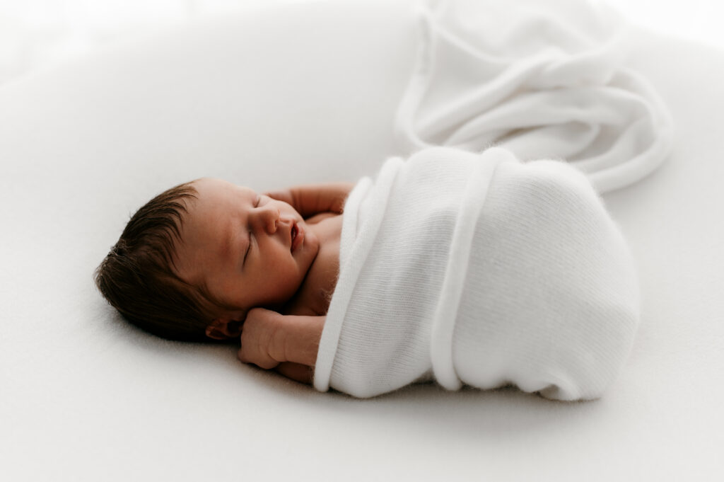 Sleepy newborn baby photographed in a neutral Somerset WI photography studio