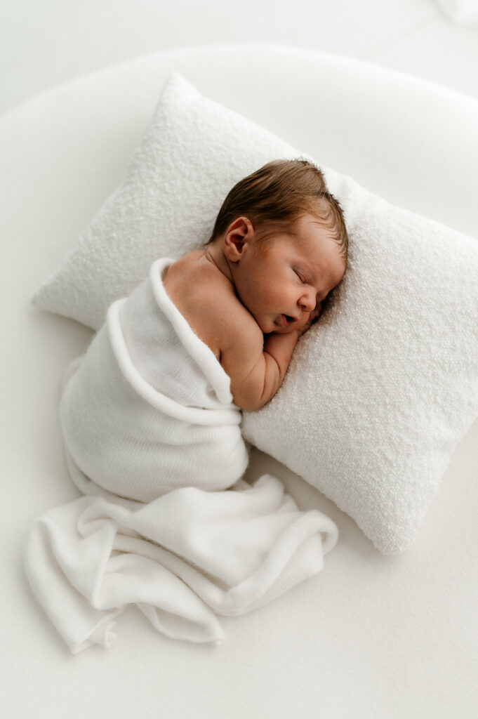 Sleepy newborn baby photographed in a neutral Somerset WI photography studio