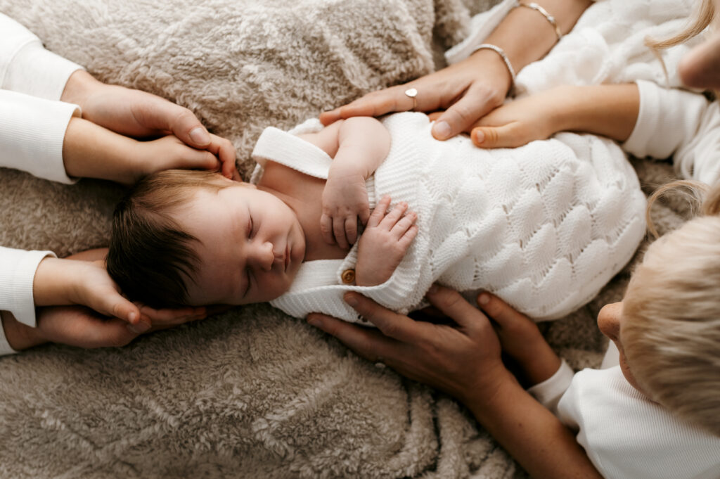 natural sibling interaction with newborn baby during lifestyle photography