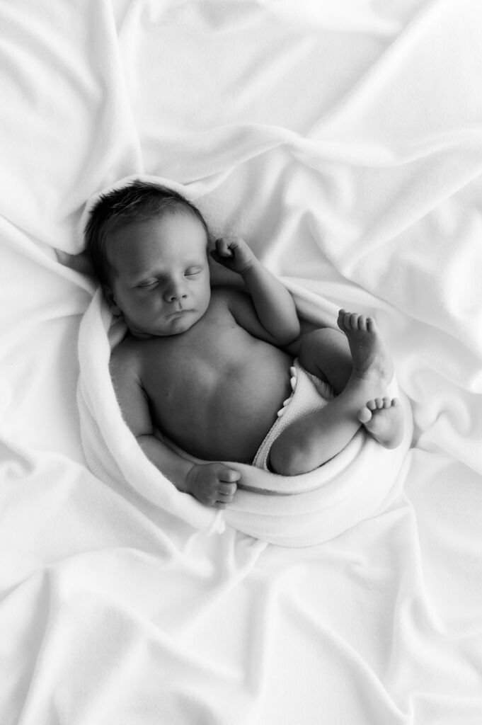 Sleepy newborn baby photographed in a neutral Somerset WI photography studio