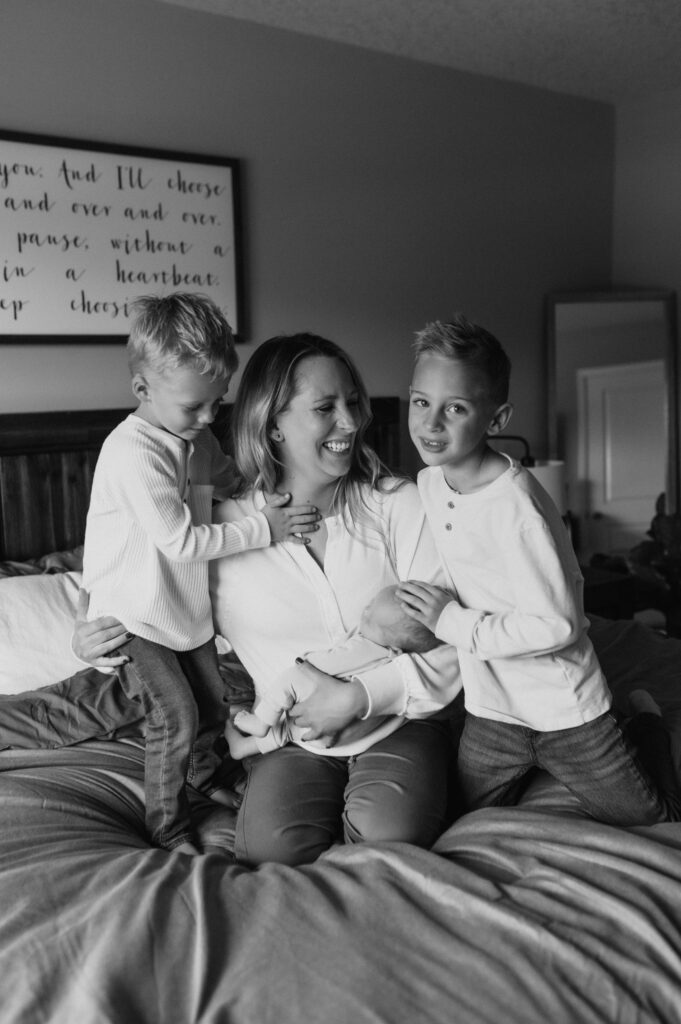 Mom holding her newborn during a relaxed in home photo session