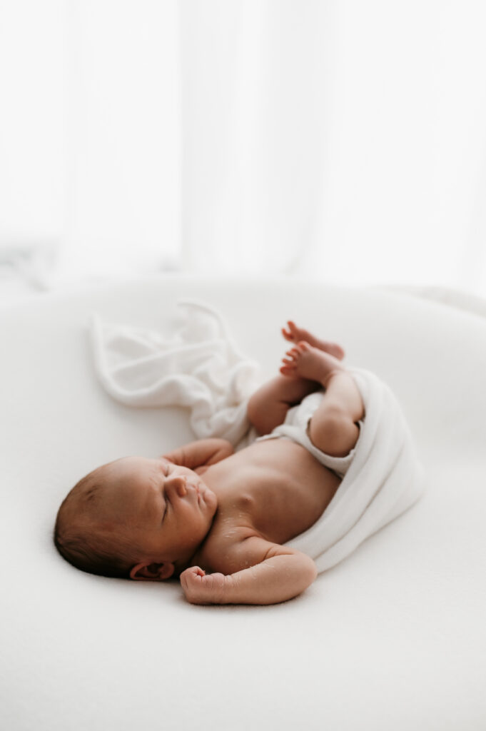 Sleepy newborn baby photographed in a neutral Somerset WI photography studio