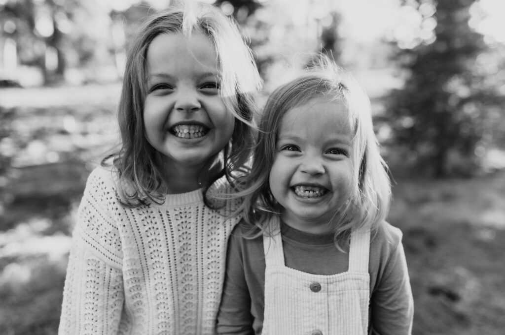 Sisters smiling big together