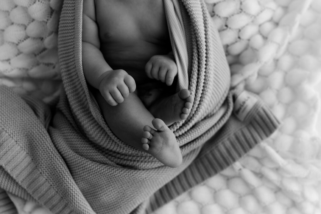 Newborn wrapped in neutral tones highlighting peaceful early days