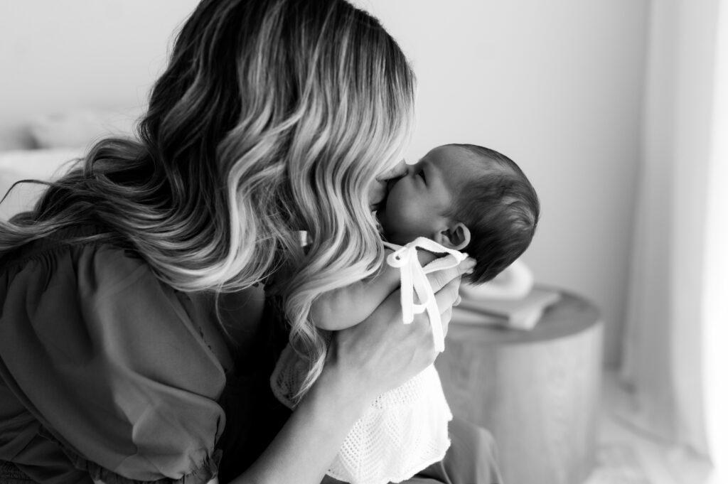 Mother cuddling baby during relaxed lifestyle newborn session
