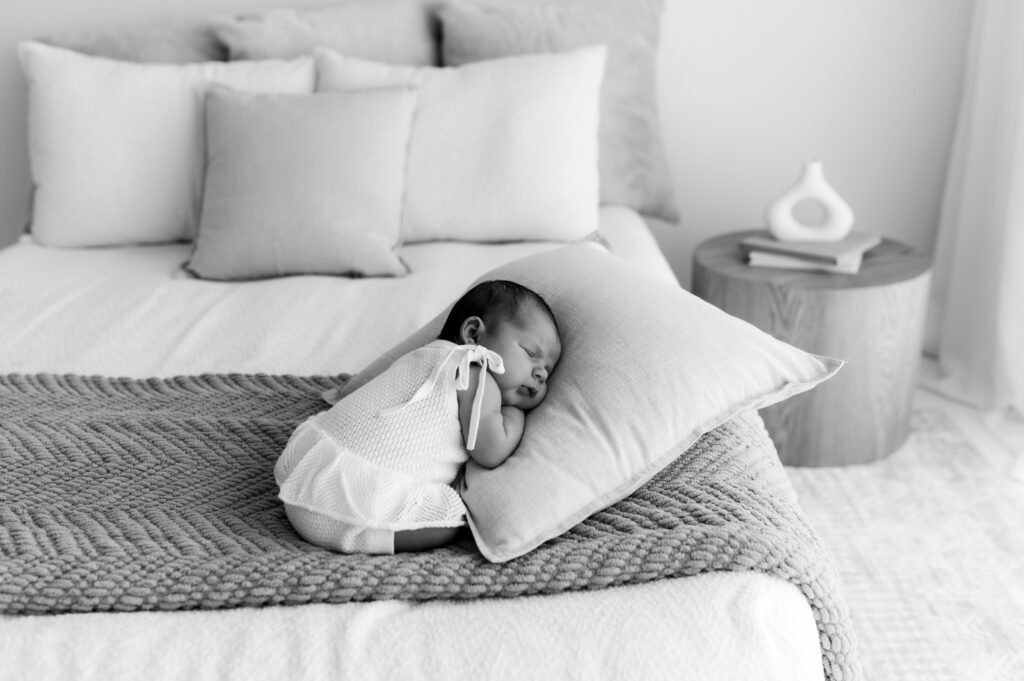 Baby laying comfortably during quiet newborn photo moment