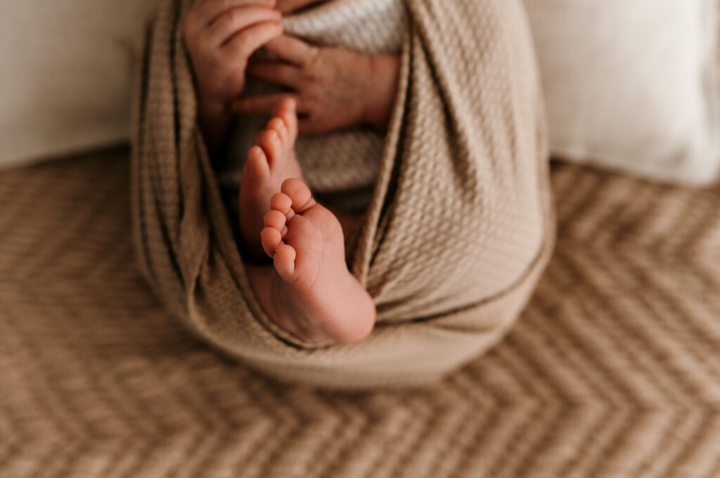 Newborn wrapped in neutral tones highlighting peaceful early days