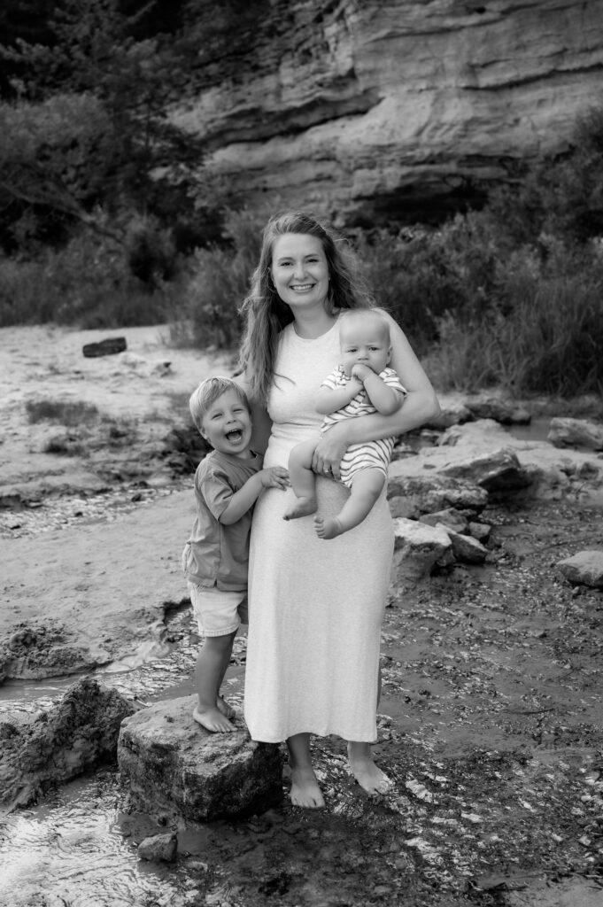 Mom and her sons being playful at a beach family session.