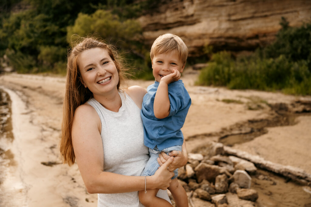 Mom with son in a candid photo on the beach.