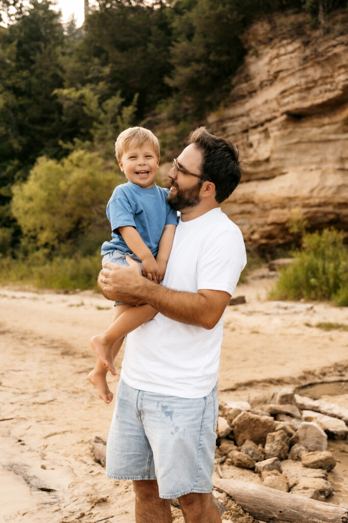 Dad and son smiling together for a photo session.
