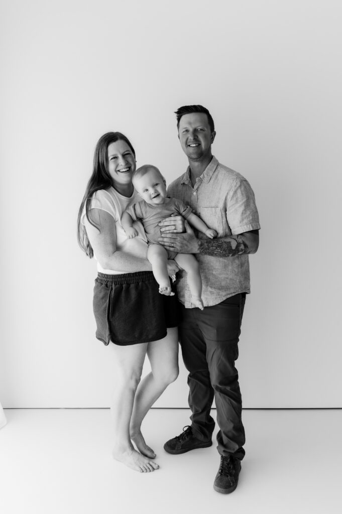 Family of three in a black and white studio photo session